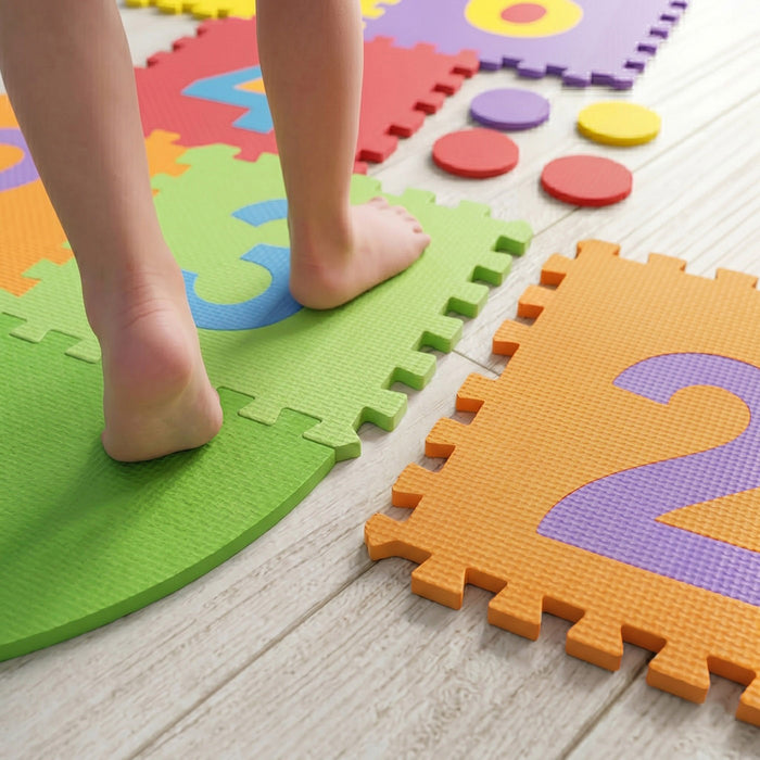 Child stepping on colourful foam puzzle mats - Dawson Sports UAE kids active play and educational toys